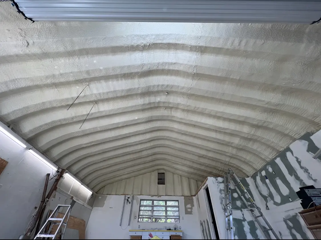 Spray polyurethane foam applied to the underside of a metal roof deck in Owatonna